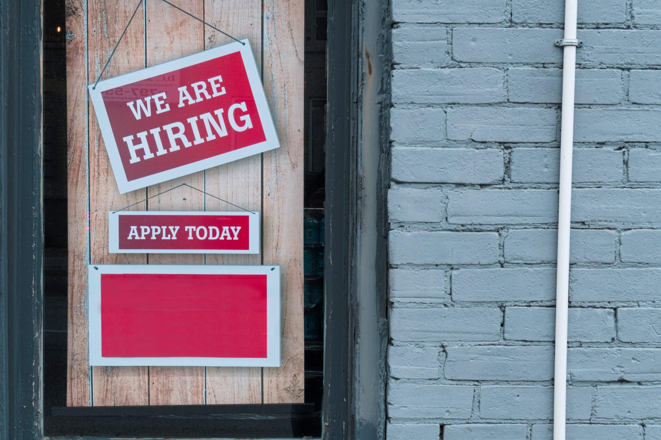 We Are Hiring sign on a wall