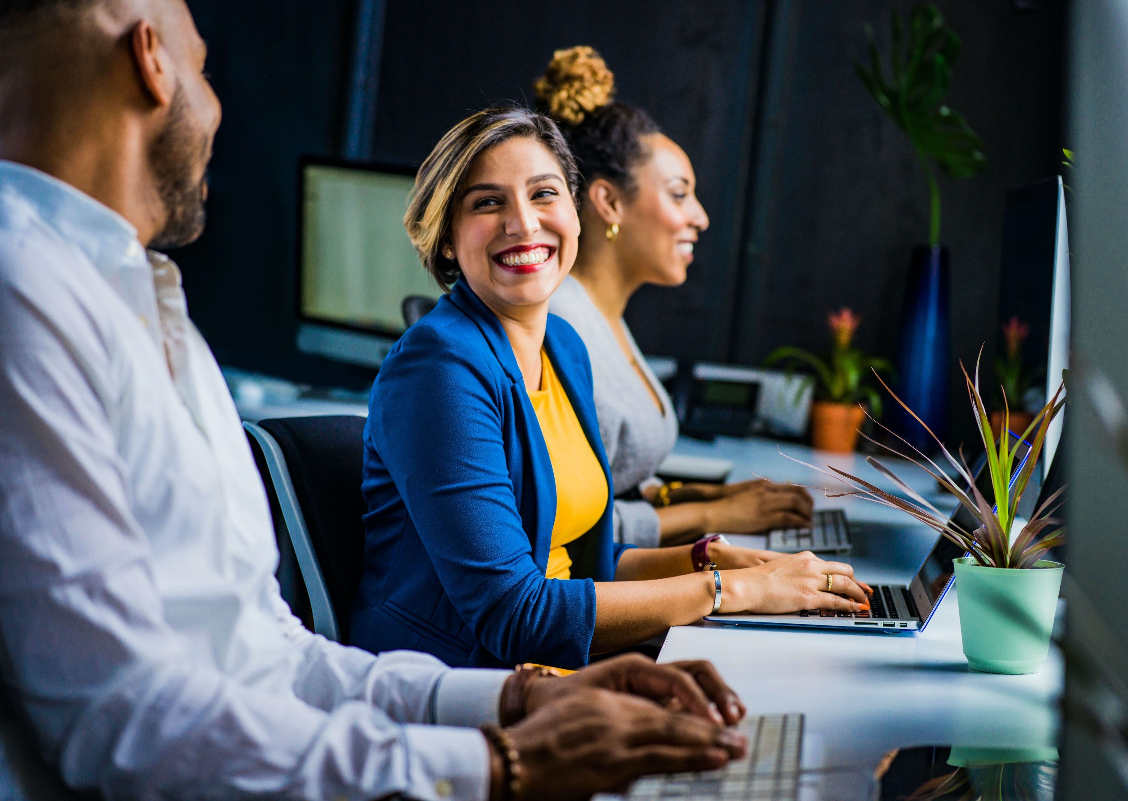 woman and man sitting at desk talking