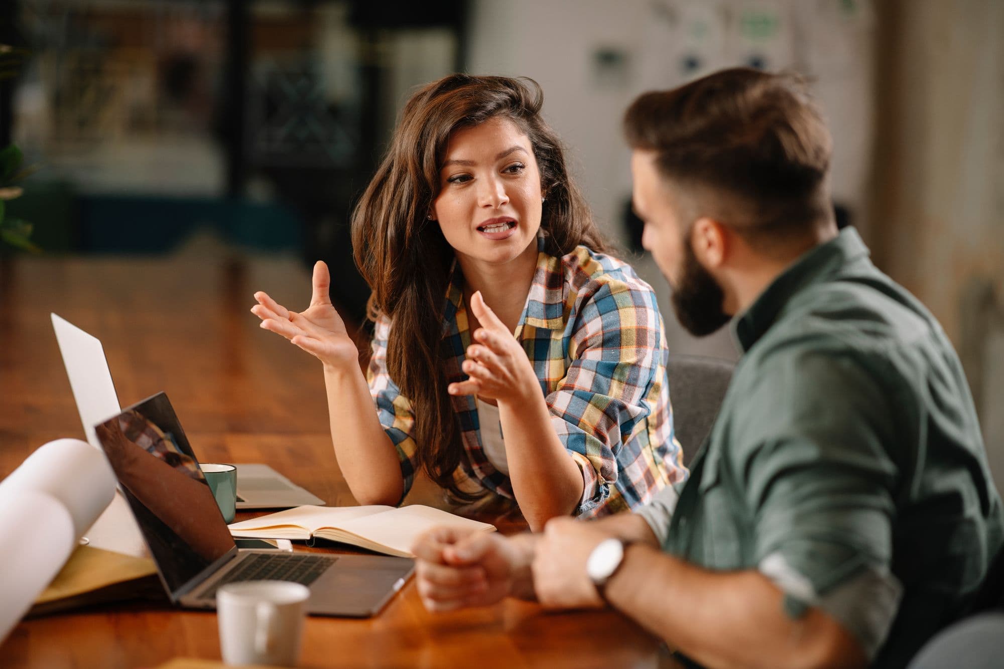 A woman and a man in conversation at a desk