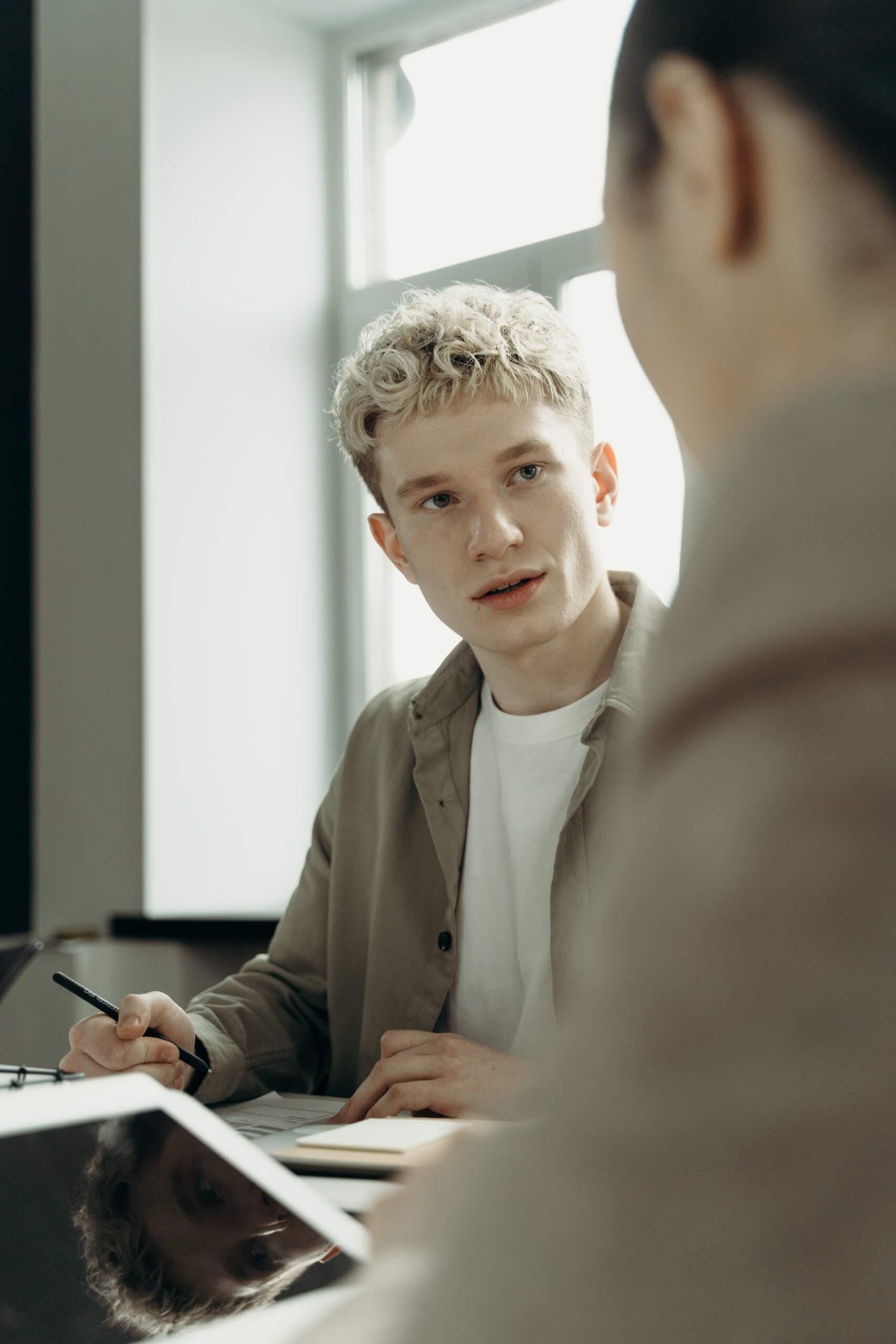 young male new hire in onboarding meeting
